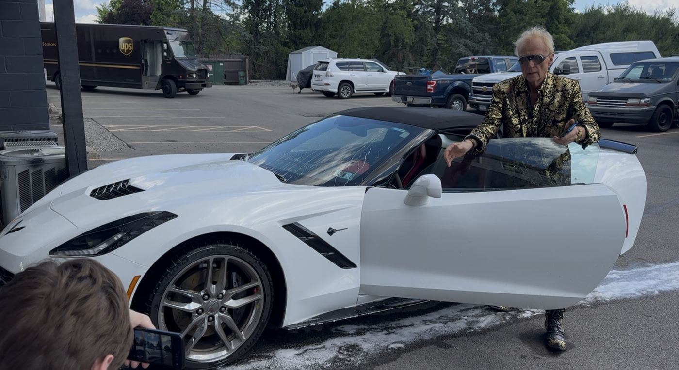 White Corvette Stingray convertible freshly detailed, owner stepping out